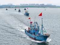 Fishing boats go out to sea from the central fishing port of Yangma Island in Yantai, China, on September 1, 2024. (