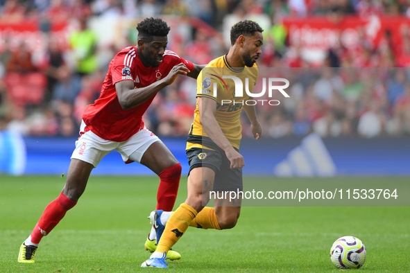 Matheus Cunha of Wolverhampton Wanderers is under pressure from Ibrahim Sangare of Nottingham Forest during the Premier League match between...