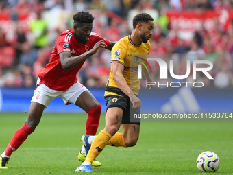 Matheus Cunha of Wolverhampton Wanderers is under pressure from Ibrahim Sangare of Nottingham Forest during the Premier League match between...