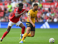 Matheus Cunha of Wolverhampton Wanderers is under pressure from Ibrahim Sangare of Nottingham Forest during the Premier League match between...