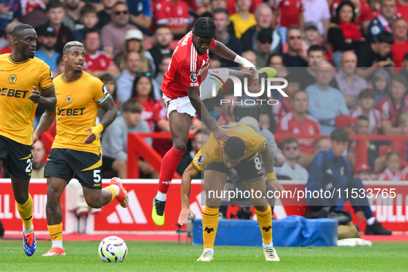 Joao Gomes of Wolverhampton Wanderers fouls Anthony Elanga of Nottingham Forest during the Premier League match between Nottingham Forest an...