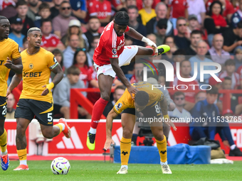 Joao Gomes of Wolverhampton Wanderers fouls Anthony Elanga of Nottingham Forest during the Premier League match between Nottingham Forest an...