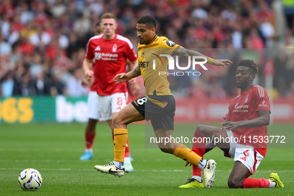 Joao Gomes of Wolverhampton Wanderers is under pressure from Ibrahim Sangare of Nottingham Forest during the Premier League match between No...