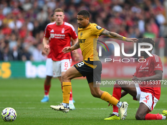 Joao Gomes of Wolverhampton Wanderers is under pressure from Ibrahim Sangare of Nottingham Forest during the Premier League match between No...