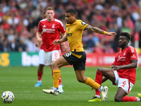 Joao Gomes of Wolverhampton Wanderers is under pressure from Ibrahim Sangare of Nottingham Forest during the Premier League match between No...