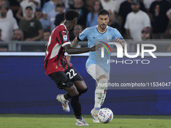 Mattia Zaccagni of S.S. Lazio competes for the ball with Emerson Royal of AC Milan during the Serie A match between Lazio and Milan at Stadi...