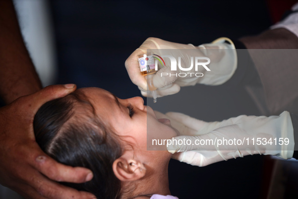 A Palestinian child receives a polio vaccination at a United Nations healthcare center in Deir Al-Balah in the central Gaza Strip, on Septem...