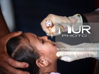 A Palestinian child receives a polio vaccination at a United Nations healthcare center in Deir Al-Balah in the central Gaza Strip, on Septem...