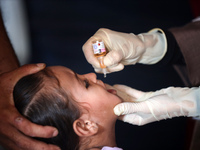 A Palestinian child receives a polio vaccination at a United Nations healthcare center in Deir Al-Balah in the central Gaza Strip, on Septem...