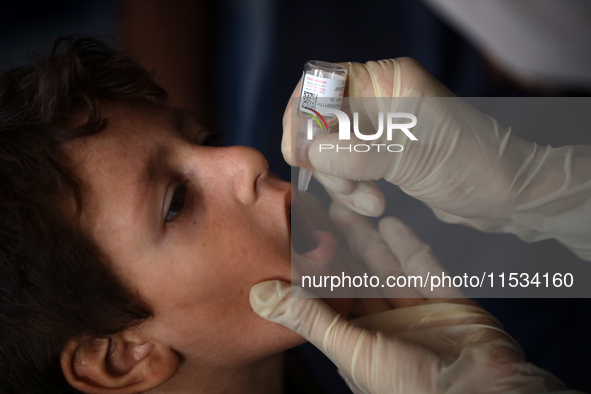 A Palestinian child receives a polio vaccination at a United Nations healthcare center in Deir Al-Balah in the central Gaza Strip, on Septem...