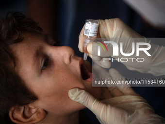 A Palestinian child receives a polio vaccination at a United Nations healthcare center in Deir Al-Balah in the central Gaza Strip, on Septem...