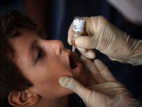 A Palestinian child receives a polio vaccination at a United Nations healthcare center in Deir Al-Balah in the central Gaza Strip, on Septem...