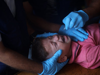 A Palestinian child receives a polio vaccination at a United Nations healthcare center in Deir Al-Balah in the central Gaza Strip, on Septem...