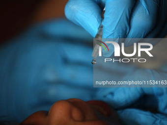 A Palestinian child receives a polio vaccination at a United Nations healthcare center in Deir Al-Balah in the central Gaza Strip, on Septem...