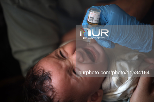 A Palestinian child receives a polio vaccination at a United Nations healthcare center in Deir Al-Balah in the central Gaza Strip, on Septem...