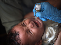 A Palestinian child receives a polio vaccination at a United Nations healthcare center in Deir Al-Balah in the central Gaza Strip, on Septem...