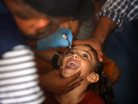 A Palestinian child receives a polio vaccination at a United Nations healthcare center in Deir Al-Balah in the central Gaza Strip, on Septem...