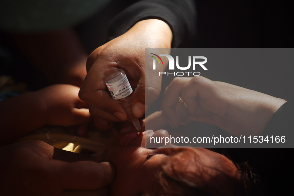 A Palestinian child receives a polio vaccination at a United Nations healthcare center in Deir Al-Balah in the central Gaza Strip, on Septem...