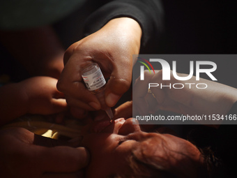 A Palestinian child receives a polio vaccination at a United Nations healthcare center in Deir Al-Balah in the central Gaza Strip, on Septem...