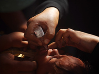 A Palestinian child receives a polio vaccination at a United Nations healthcare center in Deir Al-Balah in the central Gaza Strip, on Septem...