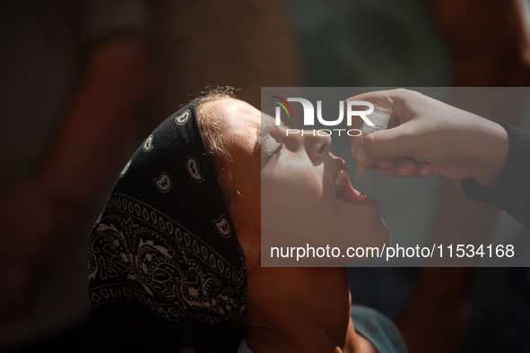 A Palestinian child receives a polio vaccination at a United Nations healthcare center in Deir Al-Balah in the central Gaza Strip, on Septem...