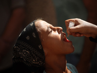 A Palestinian child receives a polio vaccination at a United Nations healthcare center in Deir Al-Balah in the central Gaza Strip, on Septem...