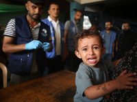 A Palestinian child receives a polio vaccination at a United Nations healthcare center in Deir Al-Balah in the central Gaza Strip, on Septem...