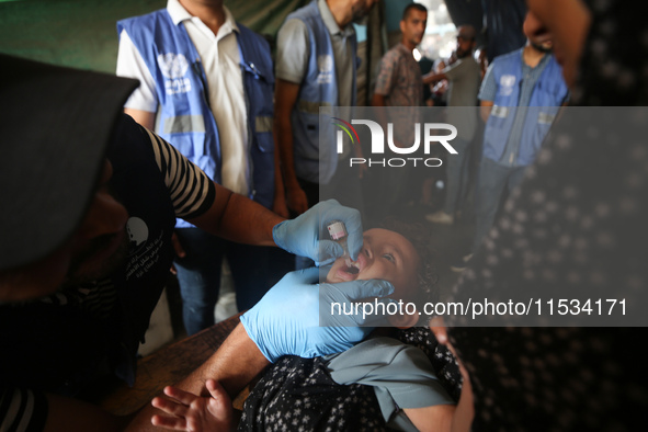 A Palestinian child receives a polio vaccination at a United Nations healthcare center in Deir Al-Balah in the central Gaza Strip, on Septem...