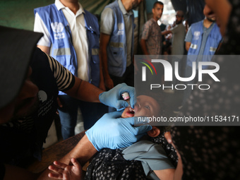 A Palestinian child receives a polio vaccination at a United Nations healthcare center in Deir Al-Balah in the central Gaza Strip, on Septem...