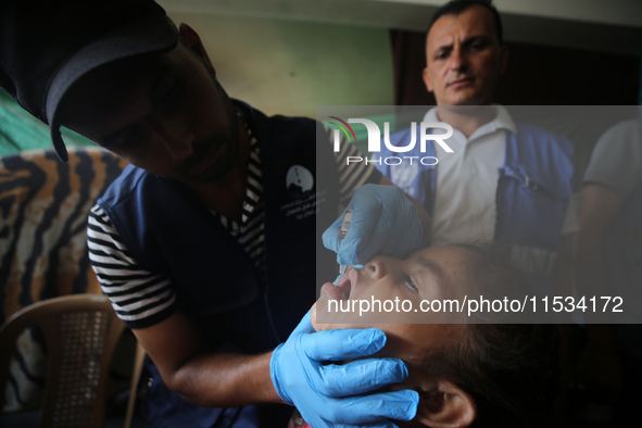 A Palestinian child receives a polio vaccination at a United Nations healthcare center in Deir Al-Balah in the central Gaza Strip, on Septem...