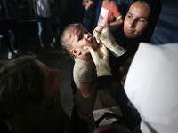 A Palestinian child receives a polio vaccination at a United Nations healthcare center in Deir Al-Balah in the central Gaza Strip, on Septem...