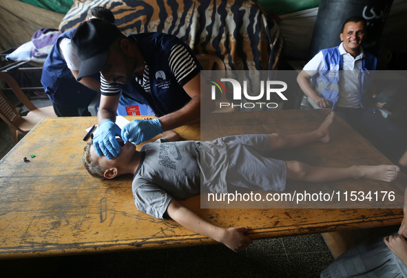 A Palestinian child receives a polio vaccination at a United Nations healthcare center in Deir Al-Balah in the central Gaza Strip, on Septem...