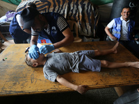 A Palestinian child receives a polio vaccination at a United Nations healthcare center in Deir Al-Balah in the central Gaza Strip, on Septem...