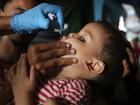 A Palestinian child receives a polio vaccination at a United Nations healthcare center in Deir Al-Balah in the central Gaza Strip, on Septem...