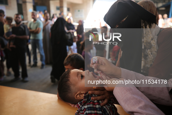 A Palestinian child receives a polio vaccination at a United Nations healthcare center in Deir Al-Balah in the central Gaza Strip, on Septem...