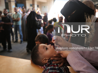 A Palestinian child receives a polio vaccination at a United Nations healthcare center in Deir Al-Balah in the central Gaza Strip, on Septem...