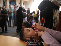 A Palestinian child receives a polio vaccination at a United Nations healthcare center in Deir Al-Balah in the central Gaza Strip, on Septem...