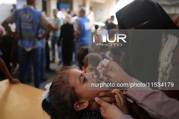 A Palestinian child receives a polio vaccination at a United Nations healthcare center in Deir Al-Balah in the central Gaza Strip, on Septem...