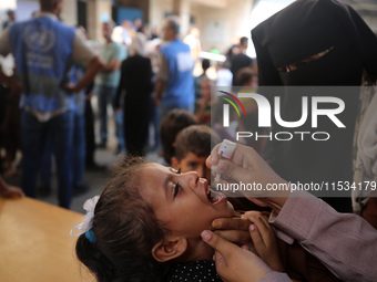 A Palestinian child receives a polio vaccination at a United Nations healthcare center in Deir Al-Balah in the central Gaza Strip, on Septem...