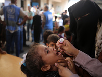 A Palestinian child receives a polio vaccination at a United Nations healthcare center in Deir Al-Balah in the central Gaza Strip, on Septem...