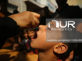 A Palestinian child receives a polio vaccination at a United Nations healthcare center in Deir Al-Balah in the central Gaza Strip, on Septem...