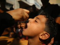 A Palestinian child receives a polio vaccination at a United Nations healthcare center in Deir Al-Balah in the central Gaza Strip, on Septem...