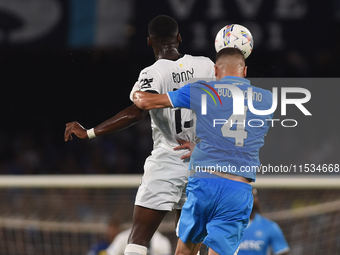 Ange-Yoan Bonny of Parma Calcio competes for the ball with Alessandro Buongiorno of SSC Napoli during the Serie A match between SSC Napoli a...