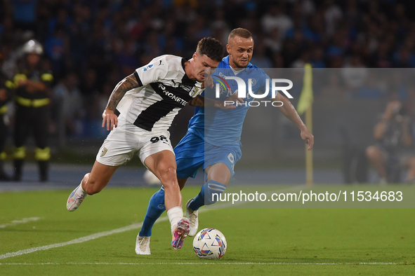 Dennis Man of Parma Calcio competes for the ball with Stanislav Lobotka of SSC Napoli during the Serie A match between SSC Napoli and Parma...