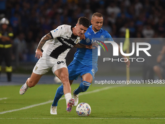 Dennis Man of Parma Calcio competes for the ball with Stanislav Lobotka of SSC Napoli during the Serie A match between SSC Napoli and Parma...