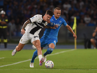 Dennis Man of Parma Calcio competes for the ball with Stanislav Lobotka of SSC Napoli during the Serie A match between SSC Napoli and Parma...