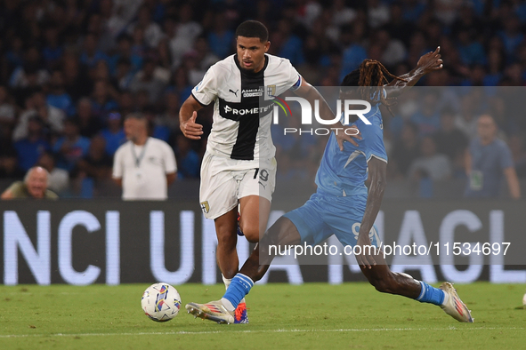 Simon Sohm of Parma Calcio competes for the ball with Andre-Frank Zambo Anguissa of SSC Napoli during the Serie A match between SSC Napoli a...