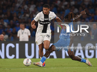 Simon Sohm of Parma Calcio competes for the ball with Andre-Frank Zambo Anguissa of SSC Napoli during the Serie A match between SSC Napoli a...