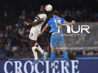 Ange-Yoan Bonny of Parma Calcio competes for the ball with Amir Rrahmani of SSC Napoli during the Serie A match between SSC Napoli and Parma...