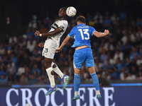 Ange-Yoan Bonny of Parma Calcio competes for the ball with Amir Rrahmani of SSC Napoli during the Serie A match between SSC Napoli and Parma...